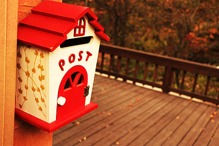 photo of white and black wooden Post Mail box near the brown wooden floor thumbnail
