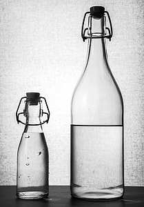 two glass bottles with clear liquid inside thumbnail