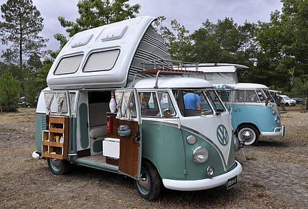 green and blue Volkswagen Samba on woods at daytime thumbnail