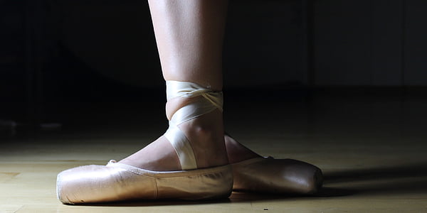 photo of ballerina on beige parquet floor thumbnail