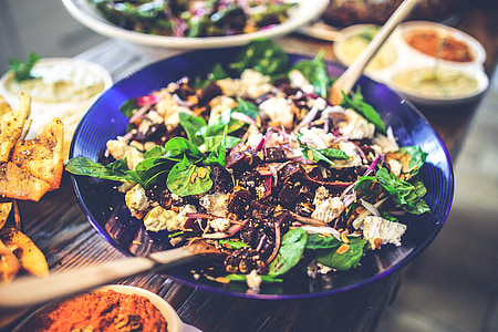 selective focus photo of bowl of vegetable salad on brown table thumbnail