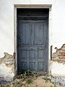 closed gray wooden 8-panel door thumbnail