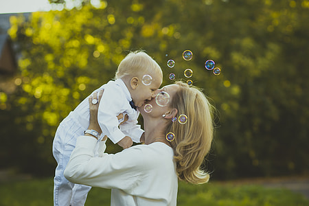 woman holding baby in long-sleeved shirt thumbnail