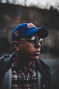 man wearing blue cap and pair of eyeglasses thumbnail