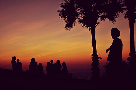people silhouette against orange sky thumbnail