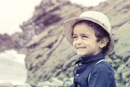boy wearing white hat and blue shirt thumbnail