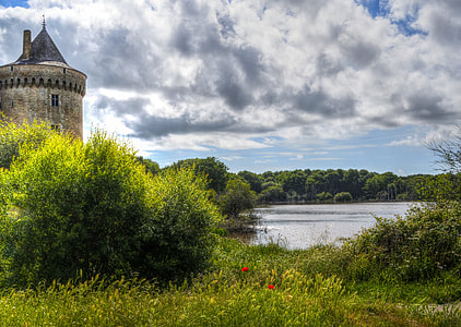 gray concrete castle beside body of water thumbnail