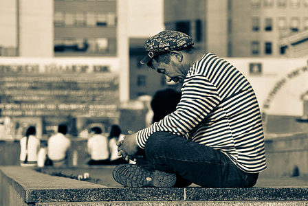 man sitting on pavement thumbnail