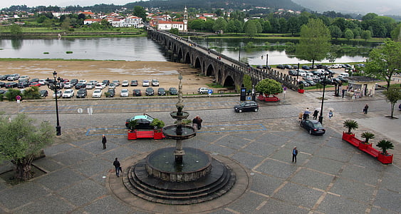 people and cars near fountain thumbnail