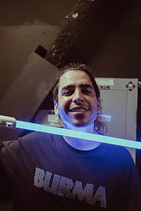 man holding lightsabre thumbnail