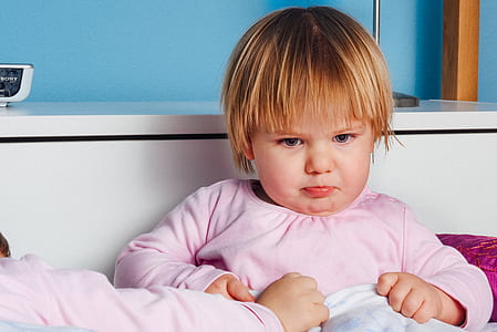 girl holding white textile thumbnail
