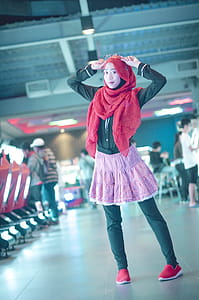 Woman in Red Head Scarf With Black Dress Shirt and Pink Skirt thumbnail
