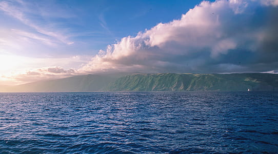 clear body of water across mountain thumbnail
