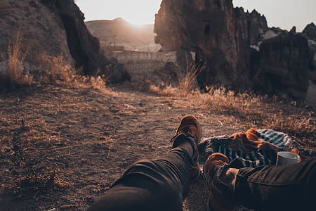 person sitting on ground near cliff thumbnail