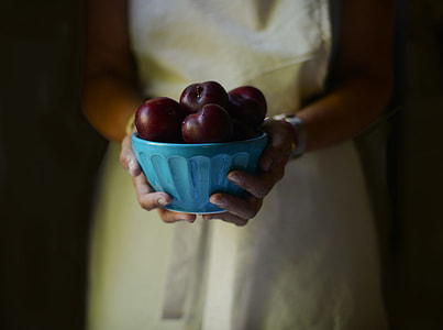 person holding bowl of apples thumbnail