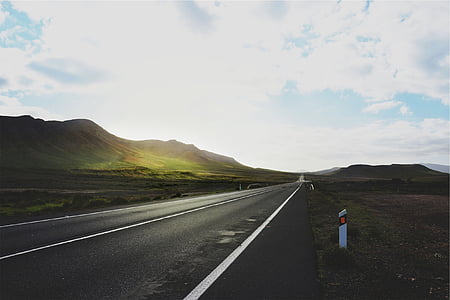 photo of asphalt road towards mountain thumbnail