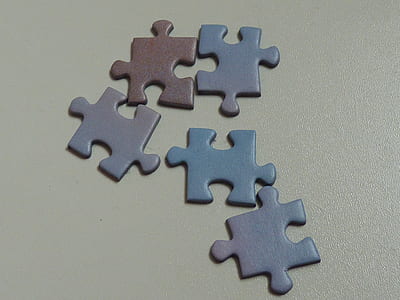 five puzzle pieces on beige surface thumbnail
