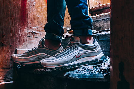 person wearing pair of gray Nike Air Max 97's thumbnail