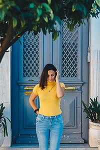 woman standing against closed door thumbnail