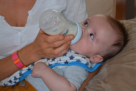 baby drinking milk on feeding bottle thumbnail