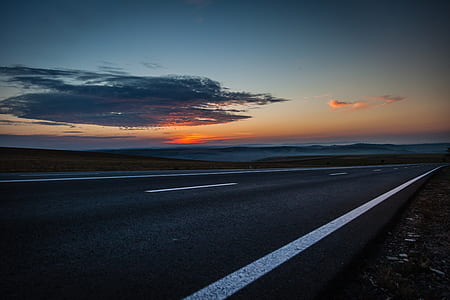 asphalt road during golden hour thumbnail