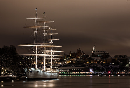 white and black lighted boat on sea during nighttime thumbnail
