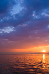 blue clouds over ocean during sunset thumbnail