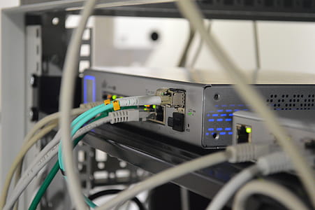 selective focus photography of white and gray metal corded device on rack thumbnail
