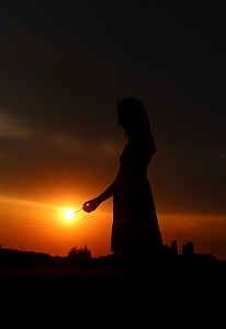 silhouette of woman during orange sunset lowlight photography thumbnail