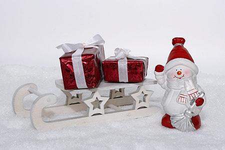 white and red snowman figurine near red and white gifts thumbnail
