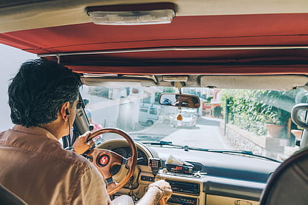 man holding vehicle steering wheel thumbnail
