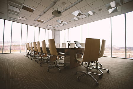empty office with table and rolling chairs thumbnail