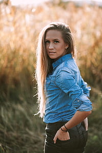 woman wearing chambray shirt with hands on back pocket thumbnail
