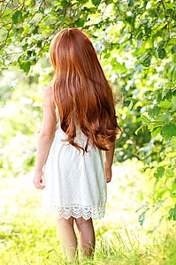 woman in white sleeveless lace dress near green tree thumbnail