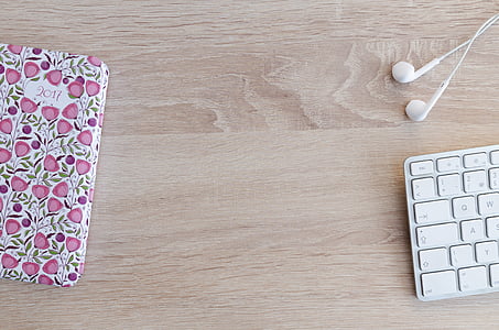 Apple AirPods on brown wooden surface thumbnail