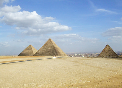 white vehicle on road near pyramid during daytime thumbnail