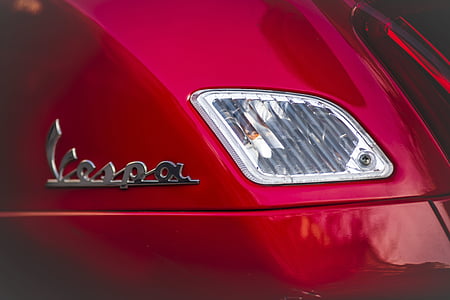 close-up photography of red Vespa motor scooter tallight thumbnail