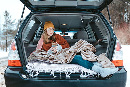 woman lying inside Subaru Forester thumbnail
