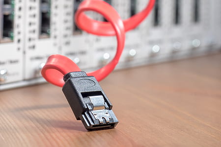 selective focus photography of USB cord on top of brown wood thumbnail