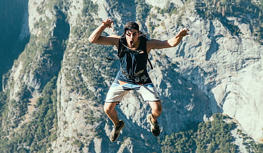 man jumping in front of mountain thumbnail