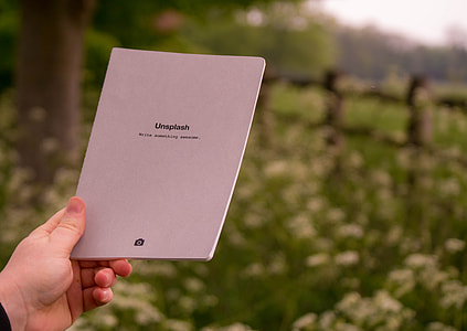 person holding Unsplash book thumbnail