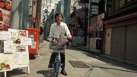 man in white dress shirt riding on bike thumbnail