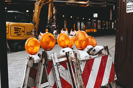 yellow excavator near boards thumbnail