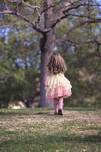 girl walking under tree thumbnail