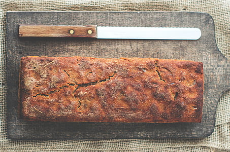 bread, bread knife, and gray pan on brown surface thumbnail