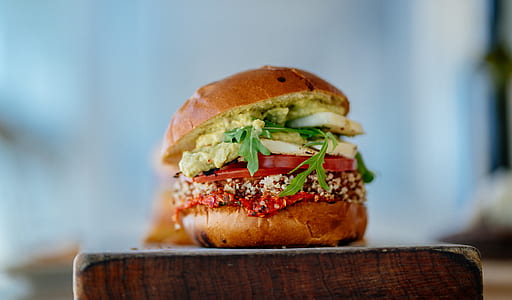 vegetable burger on brown wooden chopping block selective focus photography thumbnail