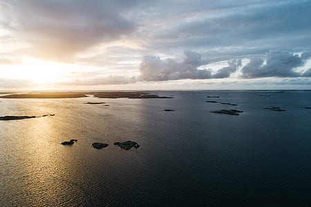 aerial photography of islets under cloudy sky thumbnail
