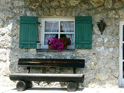 empty brown wooden bench beside gray wall thumbnail