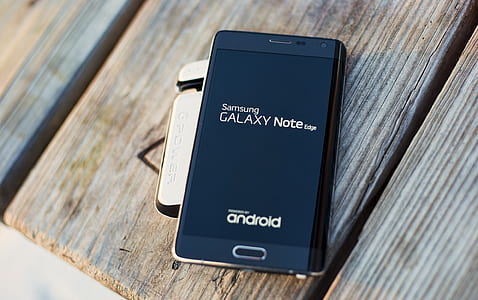 black Samsung Galaxy Note on gray wood thumbnail