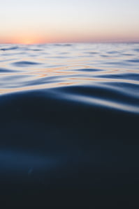 body of water under orange sky during golden hour thumbnail